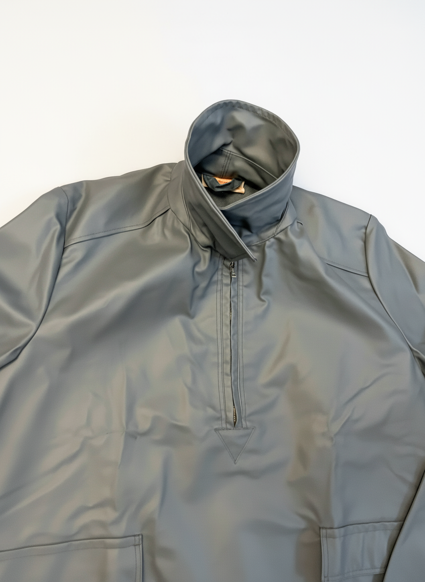 Close-up of a gray raincoat with a hood on a white background